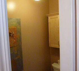 master bathroom makeover on a budget, bathroom ideas, home decor, AFTER New water conservation toilet new light fixture and my artwork