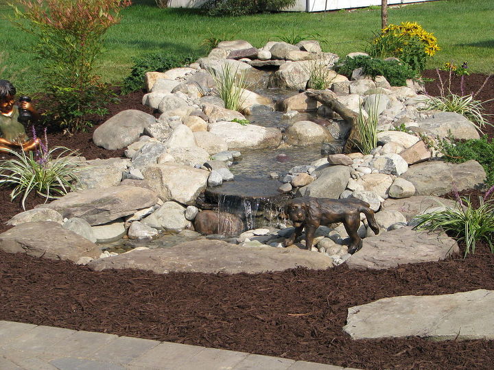 aquascape pondless and ephenry paver patio with fire pit, concrete masonry, landscape, outdoor living, ponds water features, Aquascape s Naughty dog fountain spitter adds a cute little giggle
