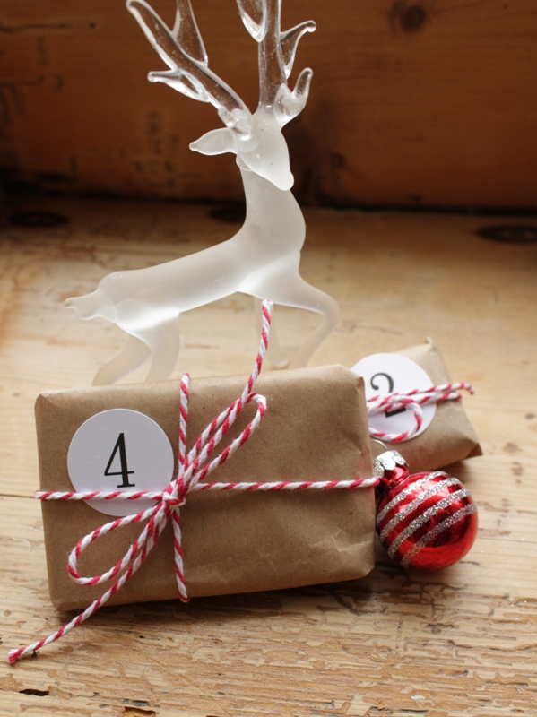 brown paper packages advent, repurposing upcycling, seasonal holiday decor, Create numbers in Word and use a circle punch to cut out
