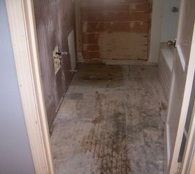 bathroom makeover turned into major bathroom remodel, bathroom ideas, diy, home decor, Everything out and old flooring removed Went with linoleum flooring that looks like tile due to budget and ease of installation
