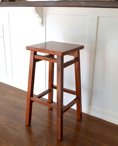 simple diy bar stool makeover, painted furniture, Before the stool s glossy reddish finish clashed with our newly redone floors and counters