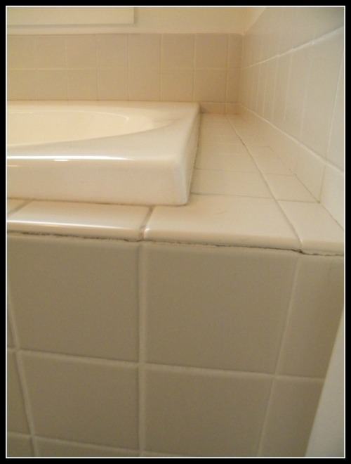 we updated our 90 s bathtub in one weekend with less than 200, It had almond colored 90s tile