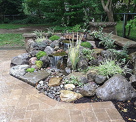landscape garden design waterfalls water feature patio sitting wall with pillars, Pondless Waterfall with Low Voltage Lighting and Rock Garden by Acorn Landscaping in Brighton NY Boulder Fountain with Waterfalls and easy to take care of Rock Garden