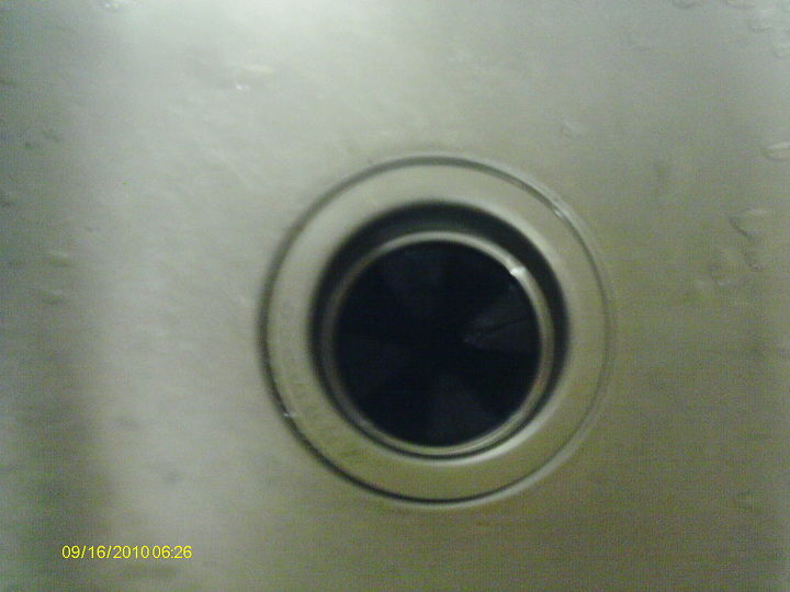 installing a garbage disposal, Clean around the opening before using new putty and installing the new flange