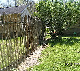 repurposed trees my son cut and made a fence for the backyard, concrete masonry, fences, outdoor living, Fence for the backyard made of repurposed tree cut