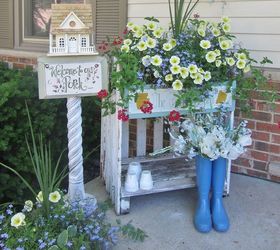 vintage summer garden, flowers, gardening, outdoor living, repurposing upcycling, On my porch I used an old vintage picket fence to make this potting table Took a bird house and placed it onto an old architectural post Using the vintage items brings character and whimsy to the garden