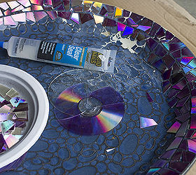 mosaic tile birdbath using recycled dvds, crafts, gardening, repurposing upcycling, After sealing the cut DVD pieces to protect the shiny layer I used a strong clear flexible adhesive to attach them to the top and edges of the birdbath
