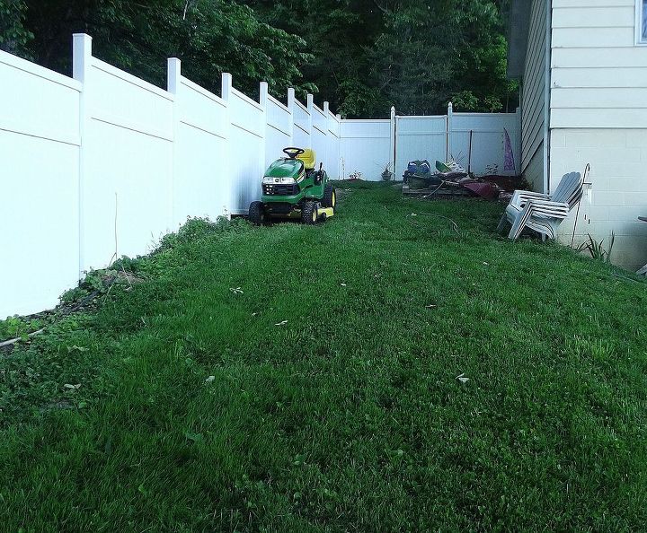 sloped backyard, diy, how to, landscape, Showing more of the fence line to show the slope of the yard Eventually the entire fence line will have plantings I just started on the other side of the yard and am making my way around