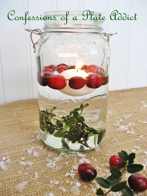 fun and easy christmas mason jar candles, christmas decorations, seasonal holiday decor, For this version you will need a floating candle fresh cranberries and some sprigs of boxwood I tied the boxwood to a nut to hold it at the bottom of the Mason jar Then simply add water a floating candle and fresh cranberries