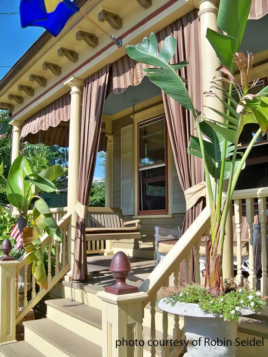 make your porch extra special with curtains, porches, This porch combines panels and valances for a cabana look that is followed through in the tropical looking plantings