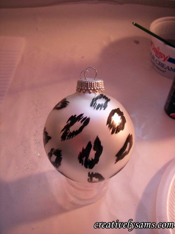 snow leopard ornaments tutorial, christmas decorations, crafts, seasonal holiday decor, The second style of leopard spots Using the flat brush I made lines of black paint in an oval pattern Let dry Clean all of the black paint from the paint brush once you re done putting in your oval patterns
