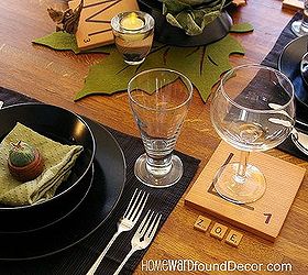 play around with your thanksgiving table decor, seasonal holiday d cor, thanksgiving decorations, Contemporary black dinnerware and clear glassware are complimented by the wood tones of the oak table and Scrabble letter tiles used as fun accents