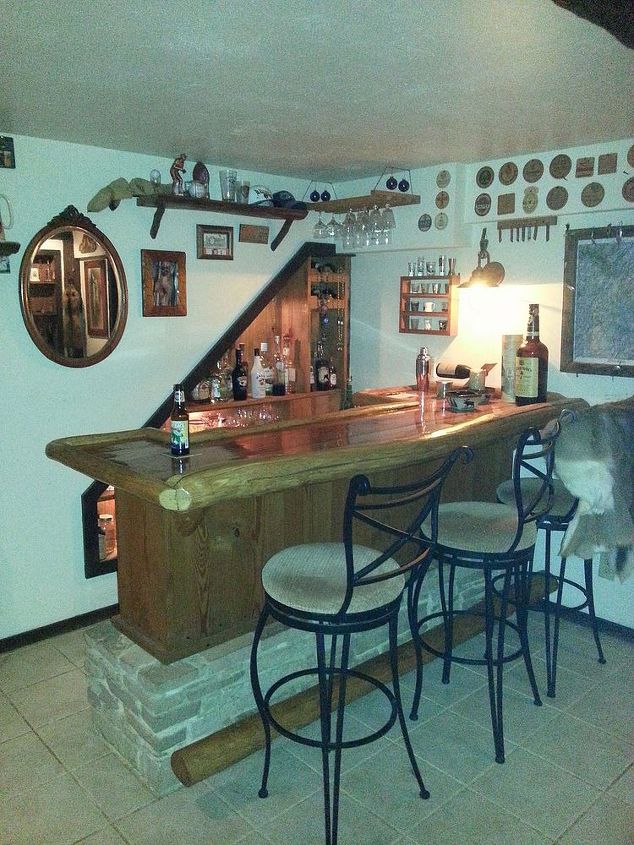 basement remodeling, basement ideas, diy, home improvement, the bar side of the basement the shelves are built into the stairwell The foot and arm rails are chestnut pole rafters and the top is oak barn siding with epoxy resin