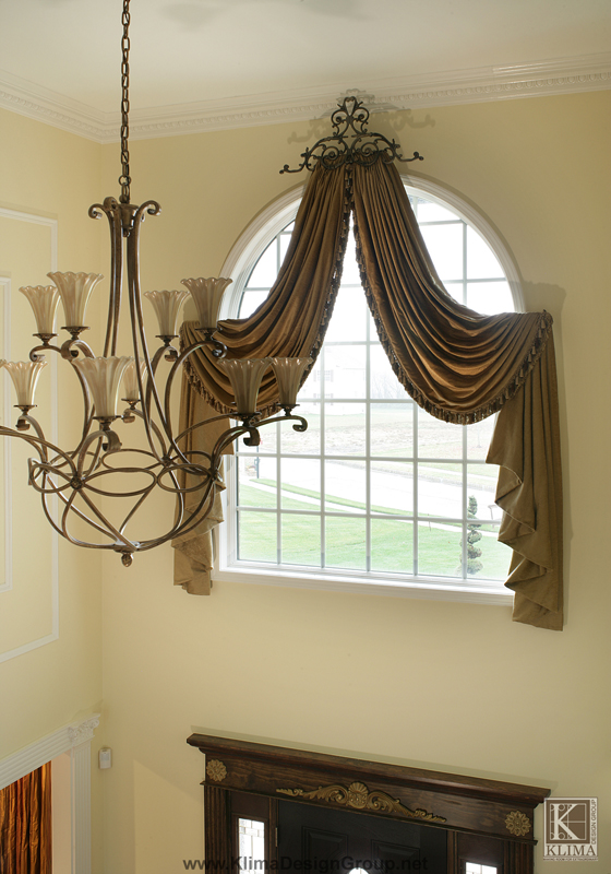 arched window drapes crowning glory 1 designer s secrets, home decor, reupholster, window treatments, windows, Arched window treatments are designed to bring together the elements in the entry such as classic and elegant chandelier that works beautifully with the drapery medallion