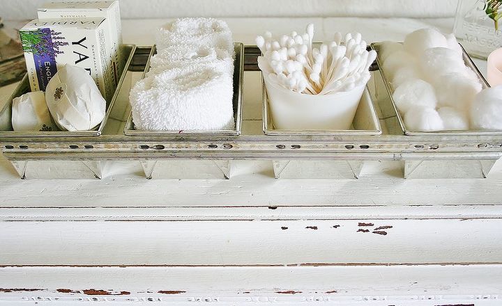making toiletries part of your bathroom decor, bathroom ideas, cleaning tips, home decor, For the guest bath I used an old factory bread loaf pan to make a serving tray of necessities for guests I set this out with a stack of white fluffy towels when overnight visitors come Just store the tray until you need it