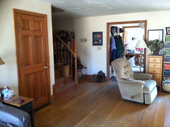 please help with furniture placement ideas, The cellar stairs are behind the door the stairs to go up are next to that and the hallway back to the bedroom is next The entryway is visible behind the chair with the kitchen beyond that