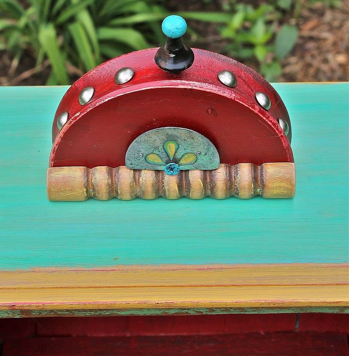 repurposed timber, diy, repurposing upcycling, Half a red wooden wagon wheel upholstery tacks finial cookie press croquet mallet