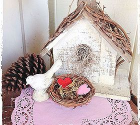 valentine s day porch, home decor, porches, seasonal holiday decor, valentines day ideas, I placed a pink doily onto the top of this vintage crate and made this love nest out of a bird nest by filling it with moss and hearts