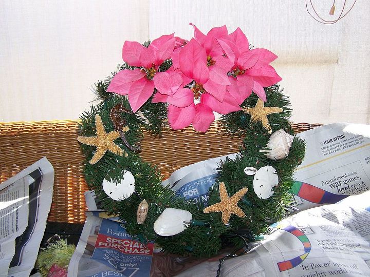 christmas wreaths i made about 5 yrs ago and forgotten about it, christmas decorations, crafts, seasonal holiday decor, They are all artificial Wreaths that has clear light and real sea shells and starfish with silk Poinesettia flowers sprayed with Shelac oh yes I forgot I used hot glue gun to set everything on the wreath
