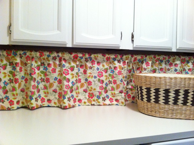 laundry room before amp after, decks, laundry rooms, I bought 2 25 yards of springy floral material on sale at Hobby Lobby for 11 00 and made a curtain to hide the water hoses and electrical and to give the room a little bit of whimsy A 10 00 shower curtain rod from WalMart holds it in place