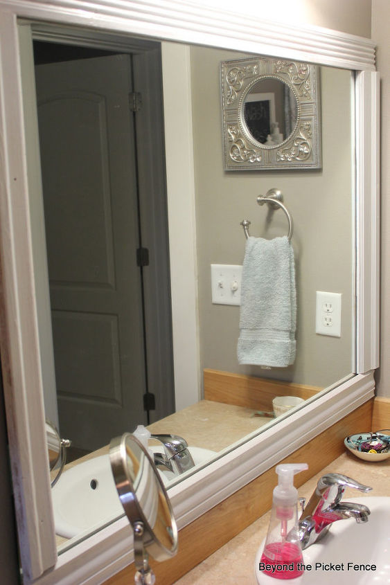 under 75 bathroom makeover, bathroom ideas, home decor, mason jars, repurposing upcycling, Add reclaimed trim to a mirror