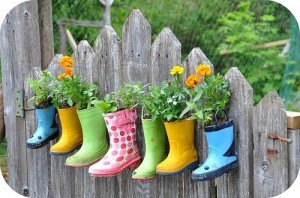 how to create a colorful and family friendly backyard, gardening, outdoor living, It just so happens that we are in the middle of spring cleaning which is perfect timing for this fun decorative upcycled planter idea for the kids I ll be pulling all of last years rain boots for this project and go looking for pai