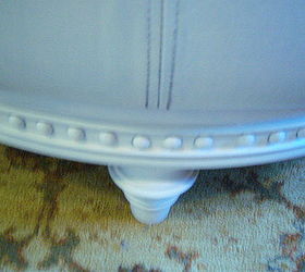 painted leather ottoman, painted furniture, Close up of the leg and wood trim