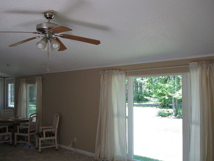 q my husband and l just purchased a small cottage in the north woods and would, home decor, living room ideas, The hallway to the right of the sofa goes to two bedrooms and a bath This photo gives some idea of the sizes of the windows in the living room With the picture window and patio doors there isn t much wall space left