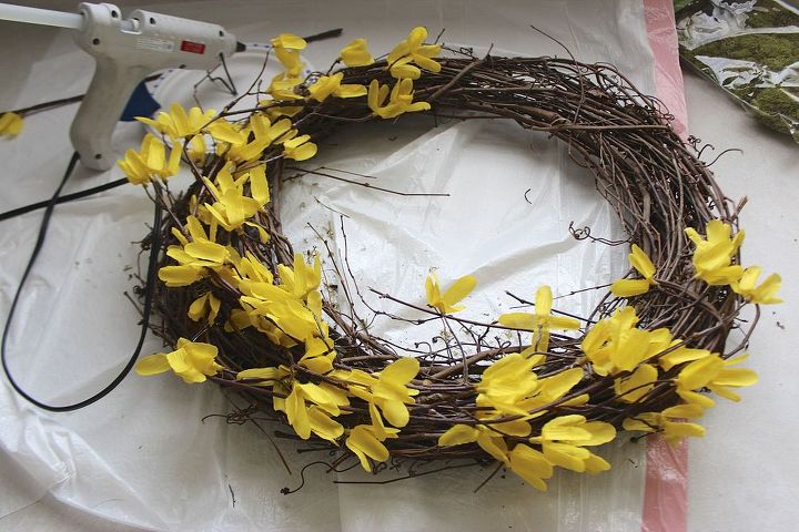 turning dollar store finds into a spring wreath, crafts, seasonal holiday decor, wreaths, Starting with a grapevine wreath from my craft stash sprigs of forsythia were hot glued in an asymmetrical pattern
