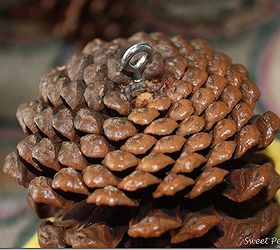 pine cone door decoration, crafts, seasonal holiday decor, A screw eye was inserted into each cone for the ribbon