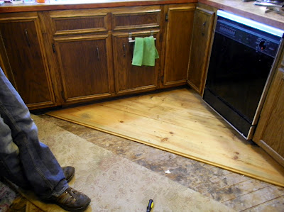 reclaimed barn wood kitchen floor, flooring, After installing new to us cabinets my husband tried his hand at floor making out of pieces of hayloft barn wood from our 1900 barn