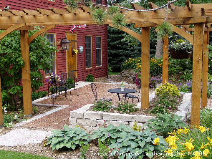 custom arbors amp pergolas by switzer s, outdoor living, A beautiful L Shaped pergola frames the front yard patio of this salt box home It provides a visual ceiling and creates a room fell A wonderful space to enjoy morning coffee and greet neighbors