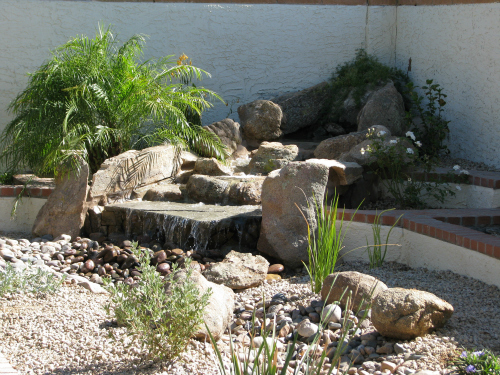 beat the heat in arizona, outdoor living, ponds water features, pool designs, The new water feature added to the area behind the conversation pit with its new gas fire feature brings life to its end of the yard