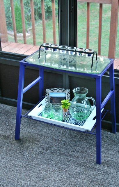 styling an outdoor entertainment table, home decor, outdoor furniture, painted furniture, The table has a candle holder on top for atmosphere and a tray on the bottom for serving