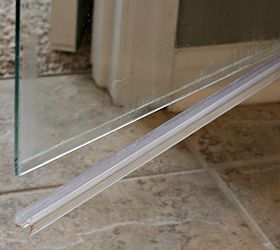 how to clean the plastic strip at the bottom of a glass shower door, bathroom ideas, cleaning tips, It was super super easy to remove plastic strip I just had to grab one end and pull down I did have to use a little muscle and tug quite a bit so keep that in mind if you try it