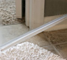 how to clean the plastic strip at the bottom of a glass shower door, bathroom ideas, cleaning tips, The glass was clean But there was soap scum and buildup underneath and on the plastic strip