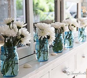 a bit of nautiical decorating with blue mason jars and flowers, home decor, Line up a row of mason jars add some flowers and sprinkle in some shells and your done