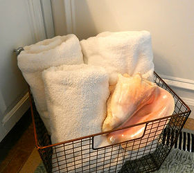 seashells and a wire basket, bathroom ideas, spas, Rolled towels in a wire basket