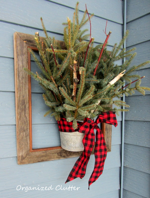 a junky rustic winter christmas front porch, christmas decorations, outdoor living, patio, porches, seasonal holiday decor, The framed greens from a previous post hang by the front door