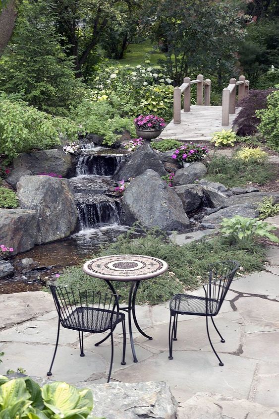 add a bridge to your pond or landscape, outdoor living, ponds water features, Just beyond the patio and wateralls a bridge over the stream beckons you to explore more