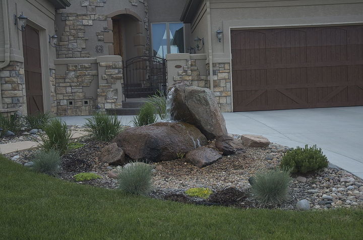 spouting rocks can stand by themselves or become a dramatic waterfall into a pond, curb appeal, landscape, ponds water features, Nothing helps to soften all the concrete of a driveway than a spouting rock water feature