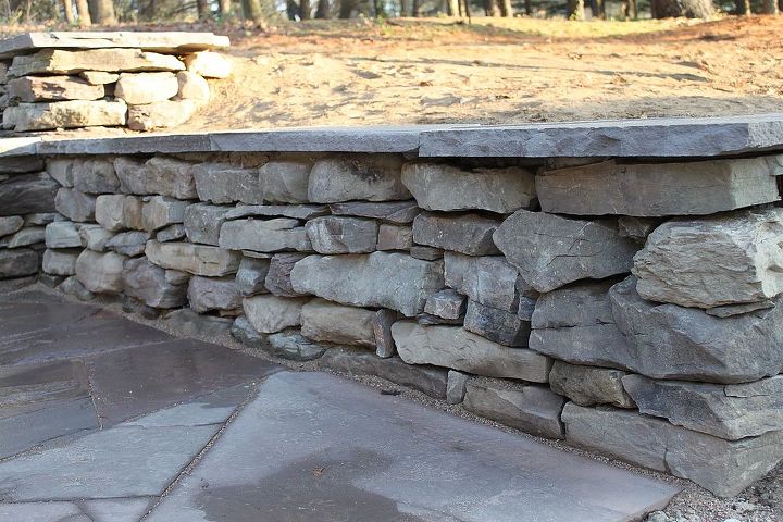 stone wall and patio with fire pit, outdoor living, patio, Natural stone wall and patio with fire pit Ypsilanti MI A close up view of the stacked stone and the flagstone cap