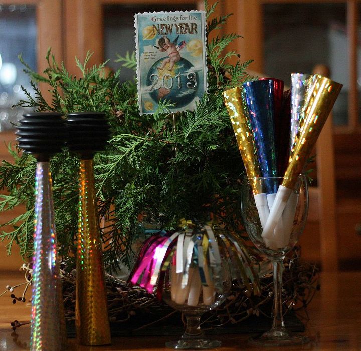 convert your evergreen centerpiece to a new year s centerpiece, christmas decorations, seasonal holiday d cor, Fresh evergreens a vintage postcard and some Dollar Tree favors make for a cute and easy New Year s centerpiece