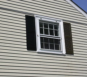 a fresh look on old shutters, curb appeal, painting, Here we are midway The left side is sprayed black the right side is untouched We ran into some bumps along the way mainly a hornets nest behind one of the shutters