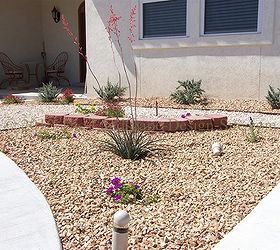 desert southwest landscaping on a small hillside circular driveway using retaining, This small wall doesn t really have any purpose to hold any slope but is just created in this area to create continuity and unity with the rest of the landscaping all other areas of the landscape have this element so it would have looked odd with out it Purely cosmetic