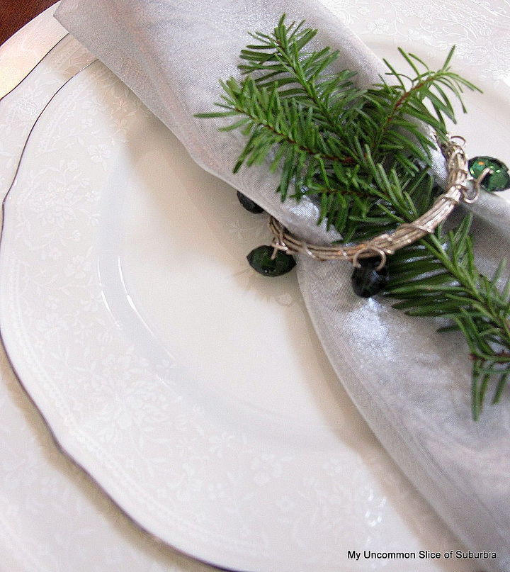 green white and silver christmas tablescape, christmas decorations, seasonal holiday decor, Fresh greens added ontop of the napkin