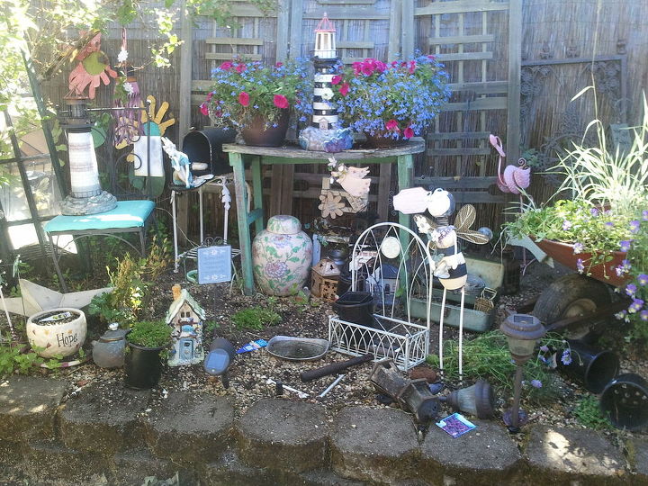 a photo of my junk pile, gardening, outdoor living, repurposing upcycling, Most of the stuff just collected over the years been trying to get some spreading things to fill in but the steppables etc don t like this and other things want to overtake so we ll see how the alyssum does