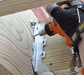 how to build a deck, decks, woodworking projects, Using a palm nailer to secure joist hangers