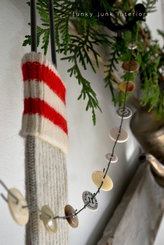 decking the halls on a horse gate headboard, bedroom ideas, christmas decorations, seasonal holiday decor, A worksock hangs from a vintage sock stretcher and a cute little button garland was created from ornament hooks Button garland tutorial is at