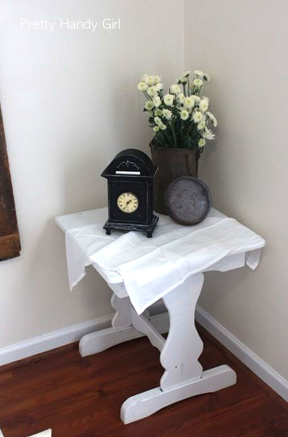 i got to collect and decorate for a family in need, chalk paint, chalkboard paint, doors, home decor, painting, repurposing upcycling, A cute little white side table holds a clock that also received chalkboard paint And I just HAD to inject a tiny bit of rust somewhere so the flower vase was the perfect discreet place